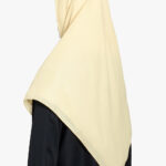 Ivory cream square hijab draped over a black abaya, providing a modest and elegant look.